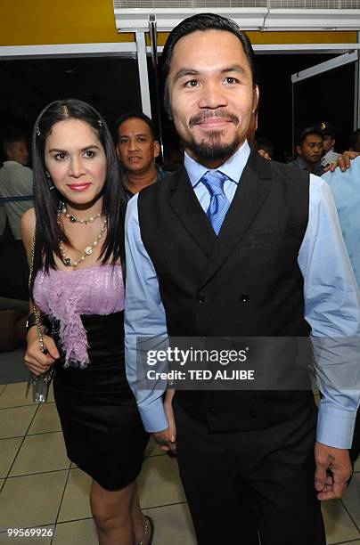 Philippine boxing superstar Manny Pacquiao and his wife Jinkee arrive for his victory party after winning a seat in the parliament, and to celebrate...