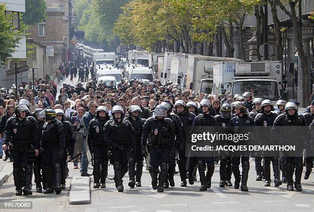 French anti-riot police forces walk ahead of people taking part in a "No Borders" demonstration to protest against France's "restrictive" policy...