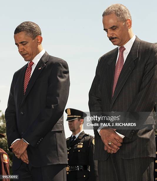 President Barack Obama and US Attorney Eric Holder bow their heads during the Twenty-Ninth annual National Peace Officers Memorial Service on May 15...