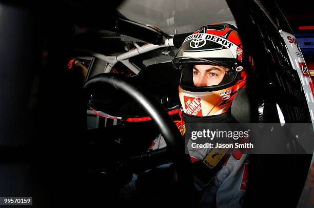 Joey Logano, driver of the The Home Depot Toyota, sits in his car during practice for the NASCAR Sprint Cup Series Autism Speaks 400 at Dover...