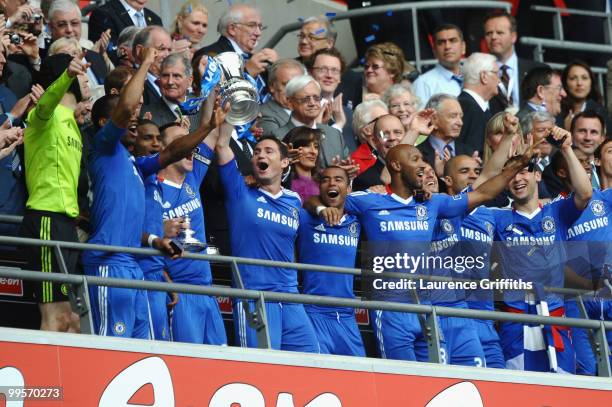 John Terry of Chelsea lifts the trophy with his team mates following their victory at the end of the FA Cup sponsored by E.ON Final match between...