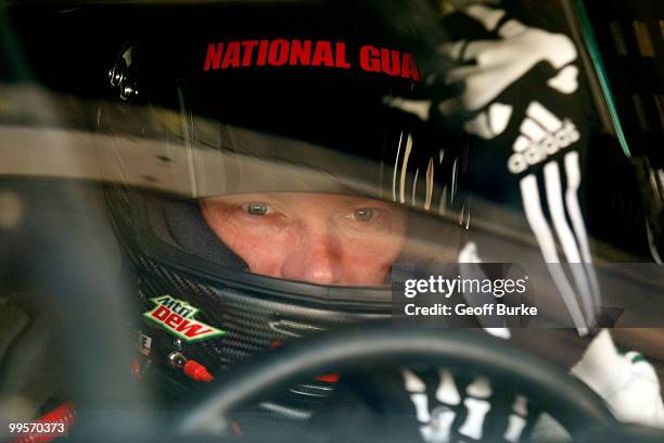 Dale Earnhardt Jr., driver of the AMP Energy/National Guard Chevrolet, puts his driving gloves on in the garage prior to practice for the NASCAR...