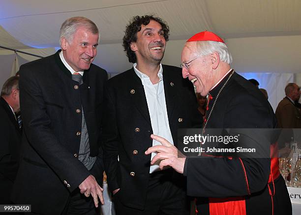 Bavarian state governor Horst Seehofer, theatre director Christian Stueckl and former cardinal Friedrich Wetter chat together during the reception of...