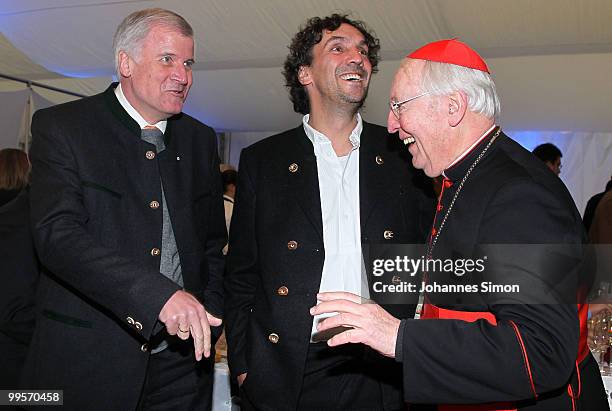 Bavarian state governor Horst Seehofer, theatre director Christian Stueckl and former cardinal Friedrich Wetter chat together during the reception of...