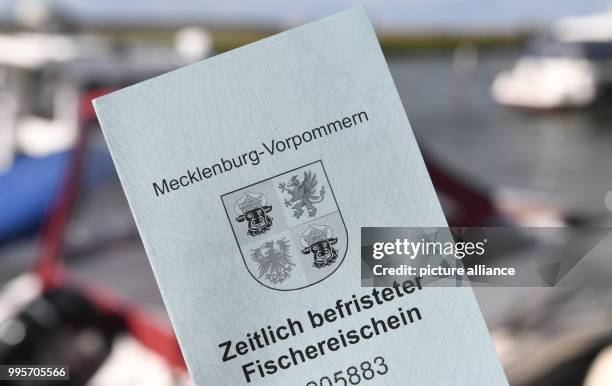 Tourist fishing licence reading 'Zeitlich befristeter Fischereischein' can be seen on Usedom island in Zecherin, Germany, 15 September 2017. The...