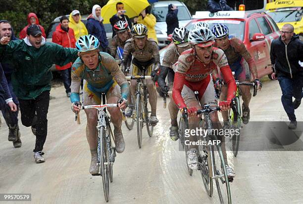 Italy's Stefano Garzelli and Alexandre Vinokourov ride on the "strade bianche" of Tuscany during the seventh stage of the 93rd Giro d'Italia going...