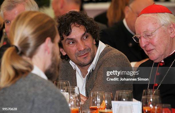 Theatre director Christian Stueckl and former cardinal Friedrich Wetter chat together during the reception of the Bavarian state governement after...