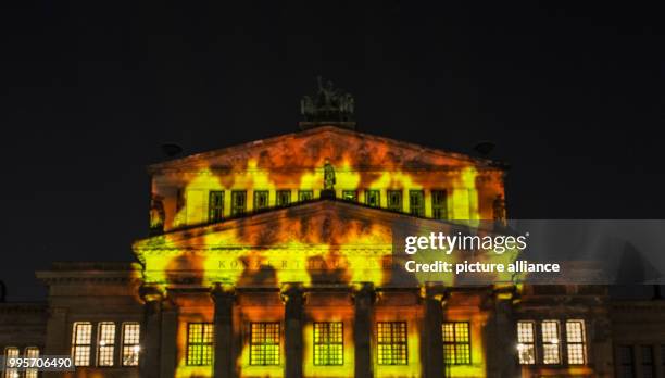 The 'Konzerthaus' music venue stands illuminated on the Gendarmenmarkt square during the kick-off event of the 'Berlin leuchtet' festival of light in...