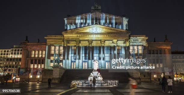 The 'Konzerthaus' music venue stands illuminated on the Gendarmenmarkt square during the kick-off event of the 'Berlin leuchtet' festival of light in...