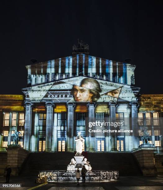 The 'Konzerthaus' music venue stands illuminated on the Gendarmenmarkt square during the kick-off event of the 'Berlin leuchtet' festival of light in...