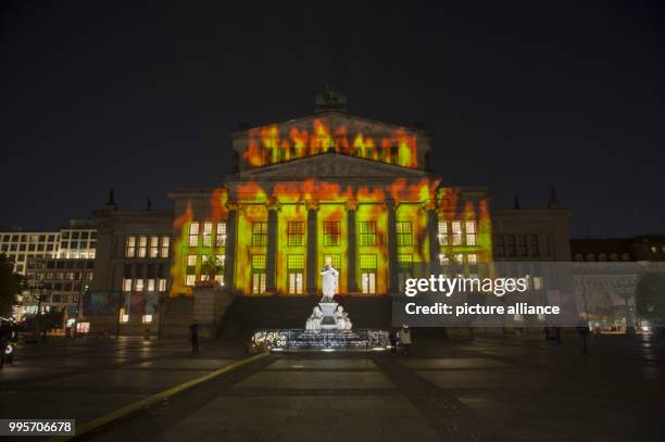 The 'Konzerthaus' music venue stands illuminated on the Gendarmenmarkt square during the kick-off event of the 'Berlin leuchtet' festival of light in...