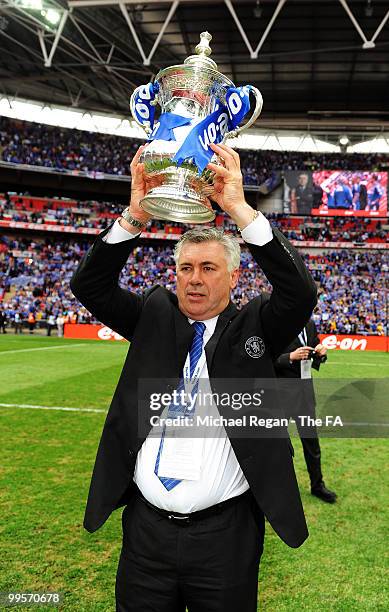 Carlo Ancelotti, manager of Chelsea, celebrates with the trophy following his team's victory in the FA Cup sponsored by E.ON Final match between...