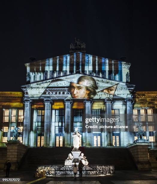 The 'Konzerthaus' music venue stands illuminated on the Gendarmenmarkt square during the kick-off event of the 'Berlin leuchtet' festival of light in...