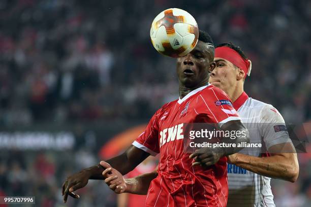 Cologne's Jhon Cordoba and Belgrade's Srdan Babic vie for the ball during the Europa League match between 1.FC Cologne and Red Star Belgrade at the...