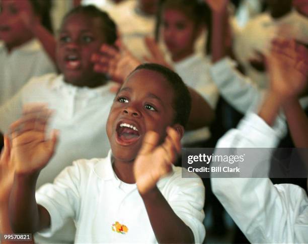 Darnell Woods, a first grader at the Cornerstone school, sings in choir class as the school rehearses for the fundraiser.