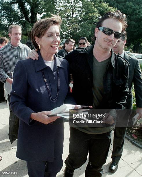 Rep. Nancy Peolosi walks with Bono of U2 to the Rayburn Building on Capitol Hill after a press conference on third world debt relief at the US...