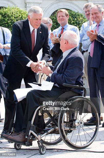 House Majority Leader Steny Hoyer shakes hands with John Lancaster, Executive Director of the National Council on Independent Living, during the news...