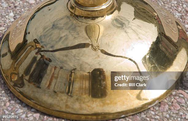 Some of the media and the Capitol Dome are reflected in one of the stanchion bases as members of Congress gather on the steps of the West Front of...