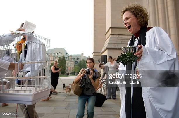 Carol Wade, Cathedral Canon Precentor, laughs as Llewellyn Bensfield steps up with her Sun Conure parrot "Gaylord" for his blessing during the...