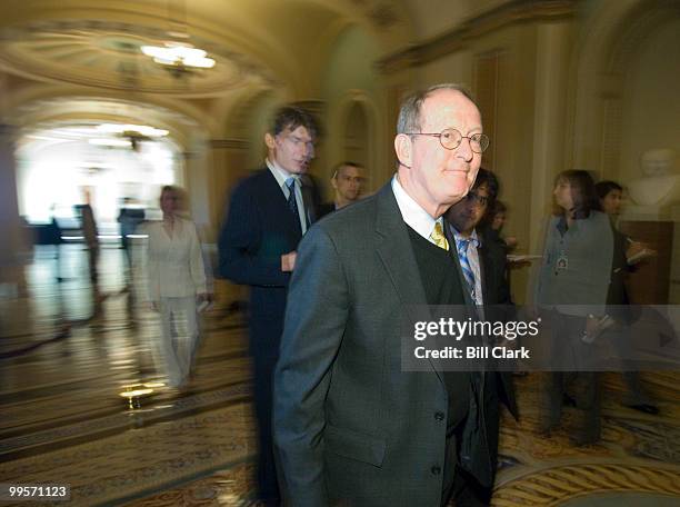 Reporters follow Sen. Lamar Alexander, R-Tenn., through the Ohio Clock Corridor in the Capitol as he heads to the weekly Republican policy luncheon...