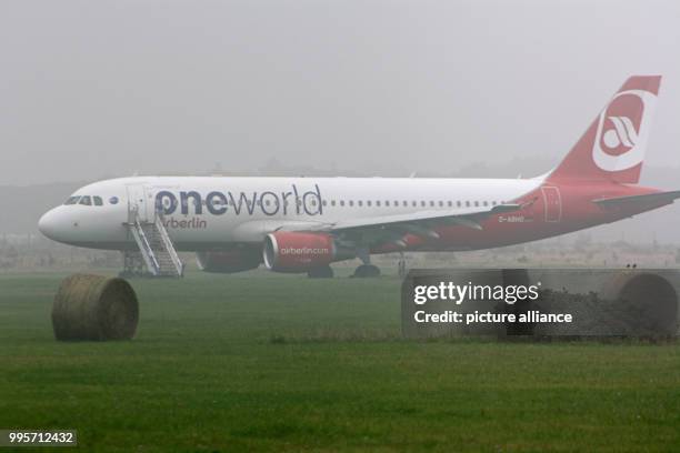 An Airbus A320 plane of the airline Air Berlin stands on a meadow at the airport in Sylt, Germany, 30 September 2017. The plane stopped only 50 meter...