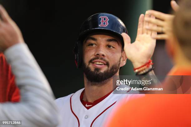 Blake Swihart of the Boston Red Sox returns to the dugout after scoring in the third inning of a game against the Texas Rangers at Fenway Park on...