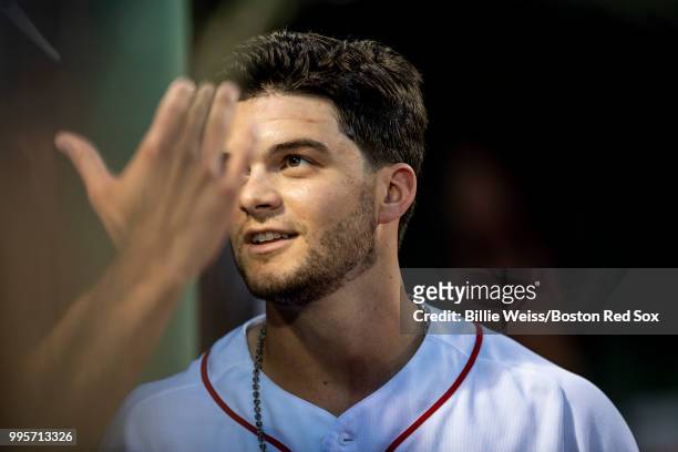 Andrew Benintendi of the Boston Red Sox reacts with teammates after scoring during the third inning of a game against the Texas Rangers on July 10,...