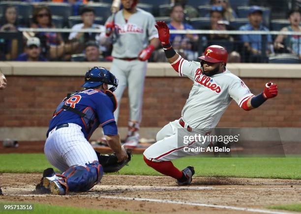 Devin Mesoraco of the New York Mets tags out Carlos Santana of the Philadelphia Phillies in the third inning during their game at Citi Field on July...