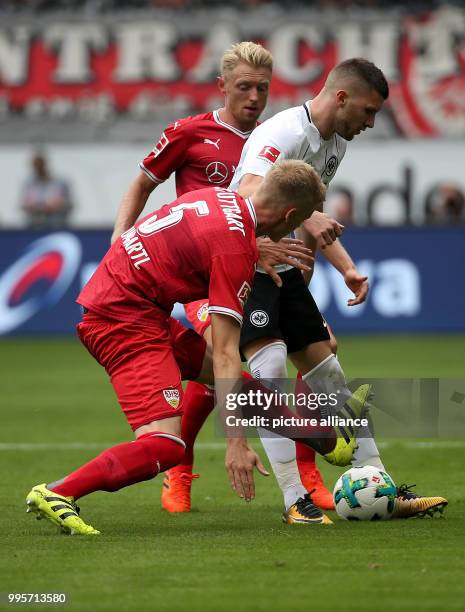 Frankfurt's Ante Rebic and Stuttgart's Andreas Beck and Timo Baumgartl vie for the ball during the German Bundesliga match between Eintrach Frankfurt...