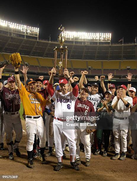 Republican coach Joe Barton, R-Texas,holds the trophy after the Republicans' win in the 46th Annual Roll Call Congressional Baseball Game at RFK...