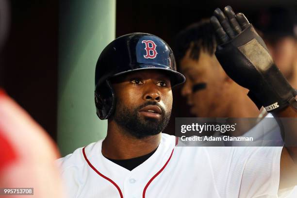 Jackie Bradley Jr. #19 of the Boston Red Sox returns to the dugout after scoring in the third inning of a game against the Texas Rangers at Fenway...