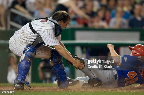 Democrats' catcher Chris Murphy applies a late tag to Republican's Adam Putnam at home plate during the Roll Call Congressional Baseball Game at...