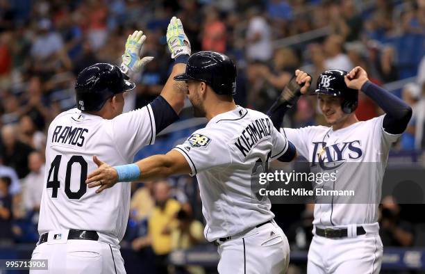 Wilson Ramos of the Tampa Bay Rays is congratulated after hitting a three run home run by Kevin Kiermaier and Daniel Robertson in the third inning...