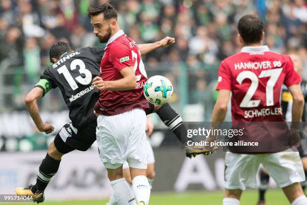 Gladbach's Lars Stindl and Hanover's Kenan Karaman vie for the ball during the German Bundesliga match between Borussia Moenchengladbach and Hanover...