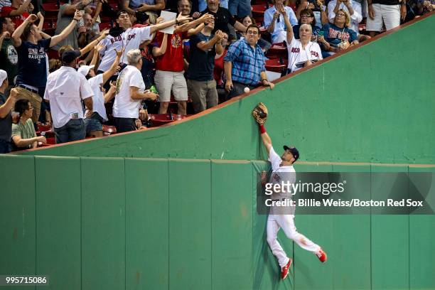 Andrew Benintendi of the Boston Red Sox attempts to catch a foul ball during the fourth inning of a game against the Texas Rangers on July 10, 2018...