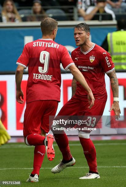 Stuttgart's Simon Terodde celebrates his equaliser goal with Daniel Ginczek during the German Bundesliga match between Eintrach Frankfurt and...