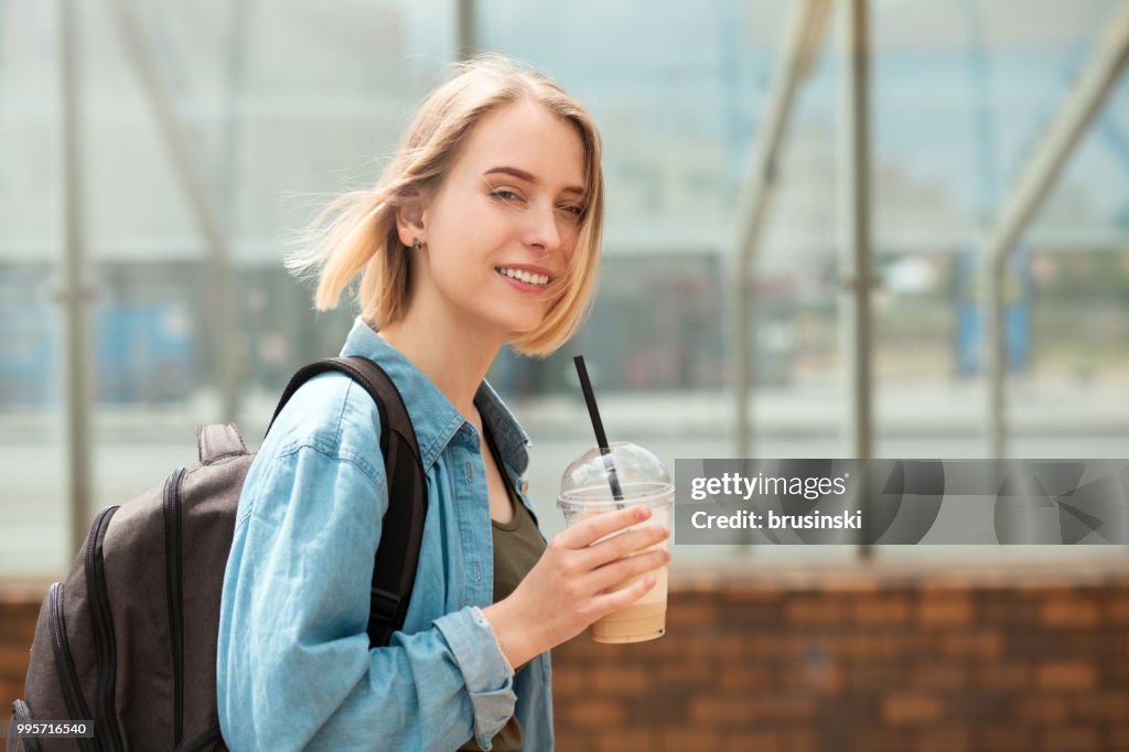 Young attractive blond woman 20 years old drinking coffee