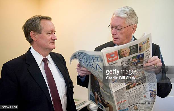 Sen. Mike Crapo, R-Idaho, watches as Sen. Jim Bunning, R-Ky., looks through USA Today's sports section to look up his grandson's team in this week's...