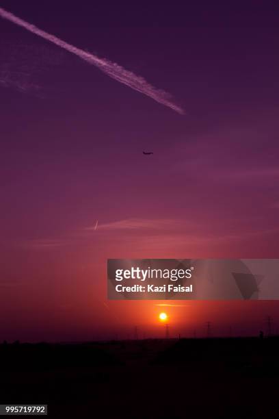 airplane in sky at sunset - faisal stock pictures, royalty-free photos & images