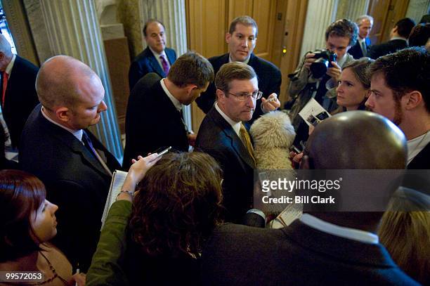 Sen. Kent Conrad, D-N. Dak., speaks to reporters on the second floor of the Capitol while holding his dog on Tuesday, Oct. 6, 2009.