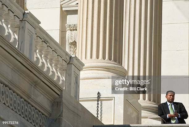 Rep. Artur Davis, D-Ala., talks on his cell phone between votes at the top of the House steps on Friday, March 19, 2010.