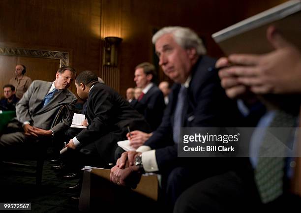 Securities and Exchange Commission Chairman Christopher Cox speaks with an aide during the Senate Banking, Housing and Urban Affairs Committee...