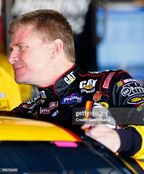 Jeff Burton, driver of the Caterpillar Chevrolet, climbs into his car prior to practice for the NASCAR Sprint Cup Series Autism Speaks 400 at Dover...