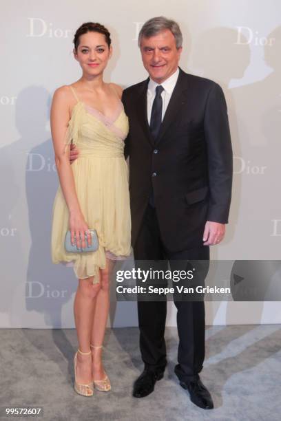 Dior president Sidney Toledano and actress Marion Cotillard pose for a photograph at the entrance of the Dior Cruise 2011 fashion show on May 15,...