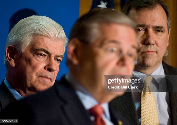 From left, Senate Banking Chairman Christopher Dodd, D-Conn., Sen. Bob Menendez, D-N.J., and Sen. Jeff Merkley, D-Ore., participate in the news...