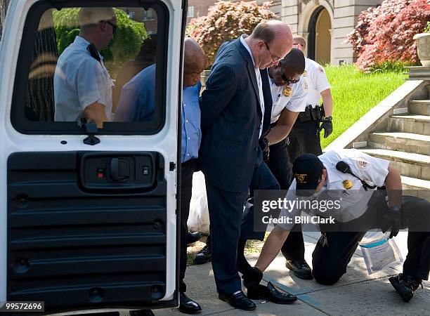 Rep. John Lewis, D-Ga., left, watches as Rep. James McGovern, D-Mass., is searched by Secret Service officers after being arrested during a protest...