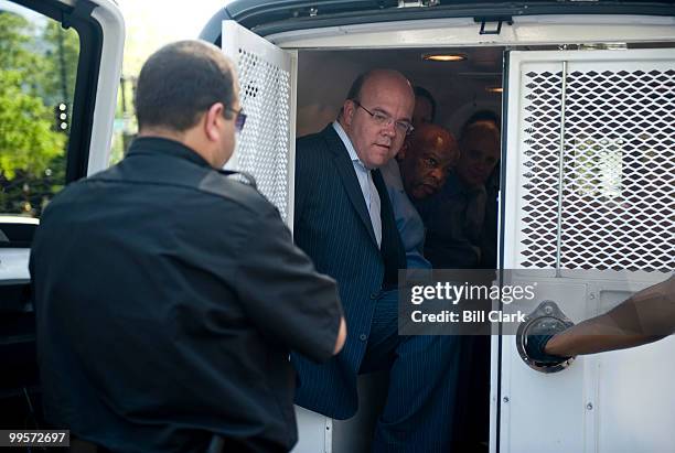 Rep. James McGovern, D-Mass., left, and Rep. John Lewis, D-Ga., sit handcuffed in the back of a Secret Service van after being arrested during a...