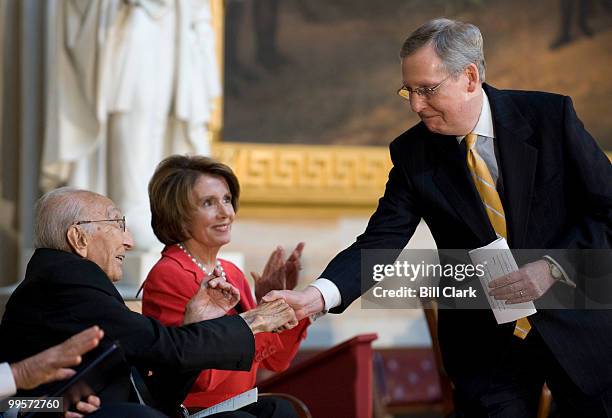 Senate Minority Leader Mitch McConnell, R-Ky., shakes hands with Dr. Michael DeBakey as Speaker of the House Nancy Pelosi, D-Calif., looks on during...