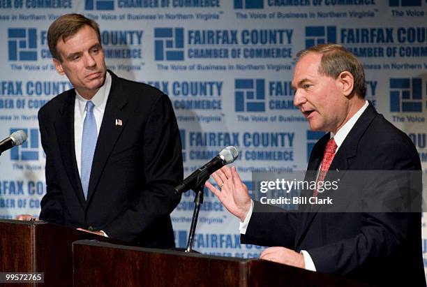 From left, U.S. Senate candidates and former Virginia Governors Mark Warner, D-Va., and Jim Gilmore, R-Va., spar on stage during a debate sponsored...