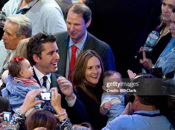 Daily Show correspondents Jason Jones, left, and Samantha Bee hold Sen. Ron Wyden's twins on the floor of the 2008 Democratic National Convention at...